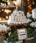 Wooden camper decor sign 'Making S'more Memories' amid marshmallow stacks at a rustic outdoor setting.