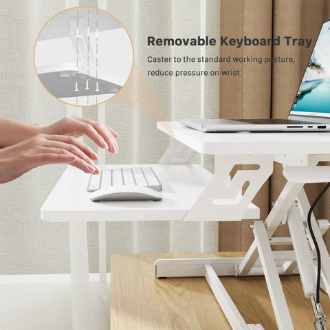 Hands using keyboard on 32 Inch Standing Desk Converter Sit Stand Riser With Keyboard Tray For Home Office Desktop and Laptop Setup