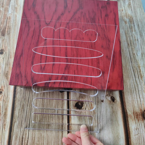 Top Shelf 6 In 1 Board Handle Router Template For Woodworking Pros Premium Clear Acrylic on a wooden table, showing different handle sizes.
