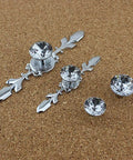 12 Pack Diamond Clear Crystal Glass Cabinet Knob Set With Plate And Screws displayed on a corkboard, close-up view.