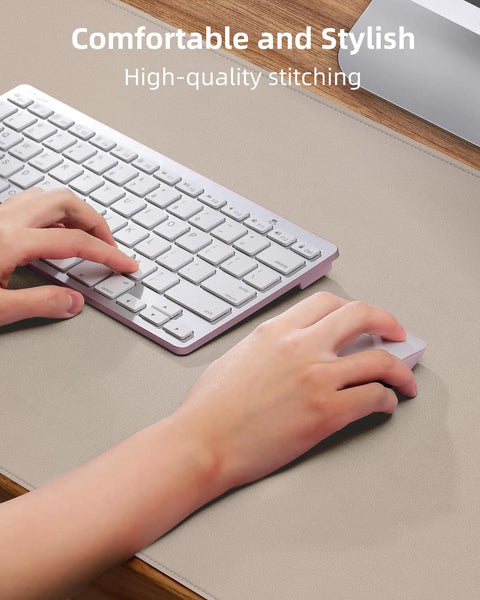 Hands using keyboard and mouse on Beige PU Leather Desk Pad Protector And Mouse Pad Large 31.5 By 15.7 Inch Non Slip Waterproof Desk Mat