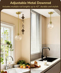 Two Pack Slick Vintage Pendant Lights With Clear Glass Globes And Gleaming Gold Canopies Adjustable Drop Length Perfect For Kitchen Islands Dining Rooms Emitting A Cozy Vibe Hardwired Installation above kitchen sink with adjustable length.