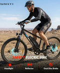 Adult Electric Mountain Bike With 26 Inch Tires And 750W Peak Motor riding on rugged terrain with 750W motor and disc brakes.