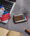 Coffee color Ultra Slim Wallet For Men With RFID Blocking 13.56 MHz, Minimalist Card Holder on desk beside laptop and cards