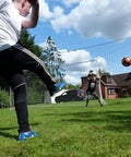 Children playing with a Backyard 3-In-1 Soccer Goal With Rebounder And Backstop Net For Solo Training And Team Practice in a yard.