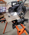 Rock Solid Folding Miter Saw Stand With Quick Three Step Setup And No Sweat Portable Design For Weekend Warrior Woodworking Projects And Ultra Compact Jobsite Storage in use with wood being cut.
