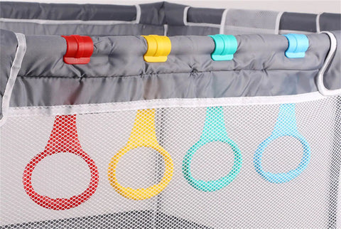 Five Color Baby Walk Assistant Rings for Toddlers Easy Stand Up Practice Tool Plastic Crib Pull Up Rings for Infant Cot Hanging Rings 3.5x7.5 Inches Bright Durable Set clipped to gray playpen rail