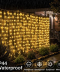 Warm White Curtain String Lights 300 LEDs 9.8x9.8 Ft Plug In Backdrop draped on a fence in the rain, IP44 waterproof