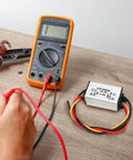 DC Buck Converter Module 24V-12V To 1.5V, 3A Output, 4.5W Power Regulator With 13cm Cable next to digital multimeter