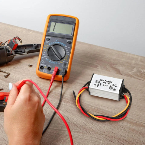 DC Buck Converter Module 24V-12V To 1.5V, 3A Output, 4.5W Power Regulator With 13cm Cable next to digital multimeter