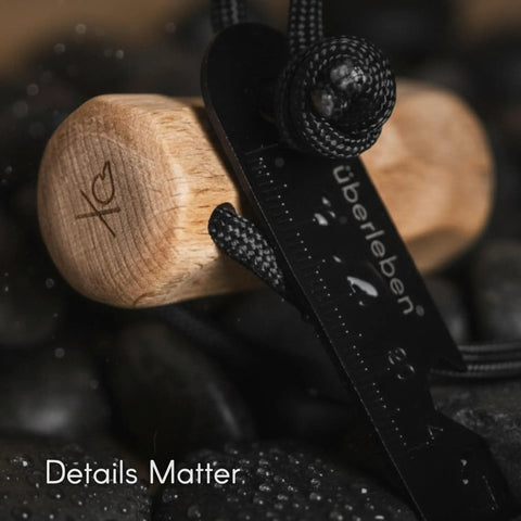 Close-up of Ferro Rod Fire Starter Survival Tool with hardwood handle, lanyard, multi-tool striker for camping essentials.