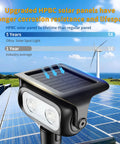 Close-up of Lit Robot Style Solar Garden Lights 4 Pack IP65 waterproof spotlight with wind turbine and solar panels.