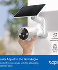 Badass 2K Plus Outdoor Wireless Security Camera With Modular Solar Panel And Rechargeable Battery For All Weathers And No Fuss Wire Free Install Featuring Rock Solid Hd Motion Detection And Night Vision mounted on a wall with solar panel.
