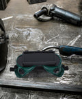 Heavy Duty Double Flip Welding Goggles With Impact Resistant Lenses and Smooth Flip Mechanism on a workshop table.
