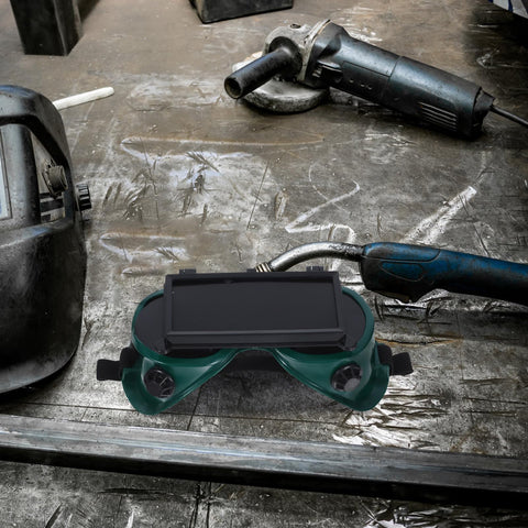 Heavy Duty Double Flip Welding Goggles With Impact Resistant Lenses and Smooth Flip Mechanism on a workshop table.