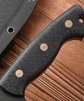 Close-up of black carbon fiber handle of Fixed Blade Knife With AUS-10 Steel, Full Tang, and Sheath for outdoor use.