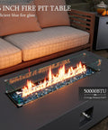 56 Inch Outdoor Propane Fire Pit Table With 50000 BTU Power, blue glass rocks, patio setup with sofa and side table.