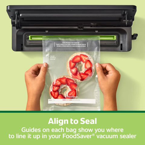 Hands holding Quart Pre Cut Vacuum Seal Bags Easy To Use Align To Seal And Tear To Open Leakproof Vacuum Sealer Storage Bags 43 Pack with bagels inside, near a sealer.