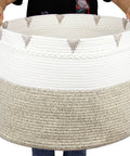 Person holding Huge Boho Blanket Basket 22 By 22 By 16 Inches Cotton Rope Storage Hamper for Throws Pillows Towels and Laundry