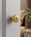 Solid Brass Cabinet Knobs And Gold Pumpkin Drawer Pulls Featuring Vintage Floral Accents For Kitchen Cupboards And Dressers Heavy Duty 6 Pack 1 1 8 Inch close-up on gold pumpkin-shaped knob on cabinet door.