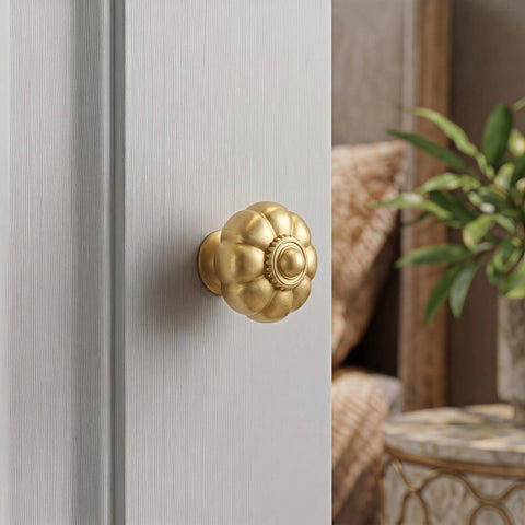 Solid Brass Cabinet Knobs And Gold Pumpkin Drawer Pulls Featuring Vintage Floral Accents For Kitchen Cupboards And Dressers Heavy Duty 6 Pack 1 1 8 Inch close-up on gold pumpkin-shaped knob on cabinet door.