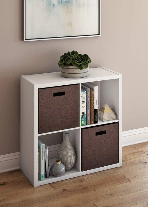 Open Back Four-Cube Storage Organizer In White with books and decor, sturdy shelving unit with bins, ideal for home or office space.