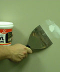 Person applying Pre-Mixed Vinyl Spackling One Quart For Interior And Exterior Use Easy To Apply With Any Putty Knife Sands Smooth