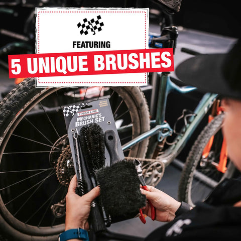 Person holding Five-Piece Mechanic-Style Bicycle Cleaning Brush Set in front of a bike, featuring 5 unique pro-grade brushes.