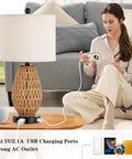 Woman using Rattan Touch Control Table Lamps Set of 2 with 3 Way Dimming for Bedroom Bedside Use Includes 2 USB Ports and AC Outlet