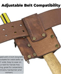 Close-up of leather tool holster with hammer loop showing adjustable belt compatibility and pencil pouch for construction tools.