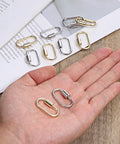 Hand holding gold and silver alloy 17x29 mm carabiners from Ten Pack Screw Carabiner Lock Charms For DIY Jewelry Making