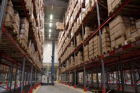 Warehouse aisle with stacked boxes and forklift; Rear Differential Mount Arm Bushing Replacement, Beefy Build Drop In OEM 50711 SH9 020 Compatible, Smooth Ride, Quieter Drivetrain, High Quality Rubber and Metal, Durable Suspension Part
