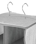 Close-up of steel hooks on soft fabric closet organizer with 20 shelf over rod vertical storage, black cream color.