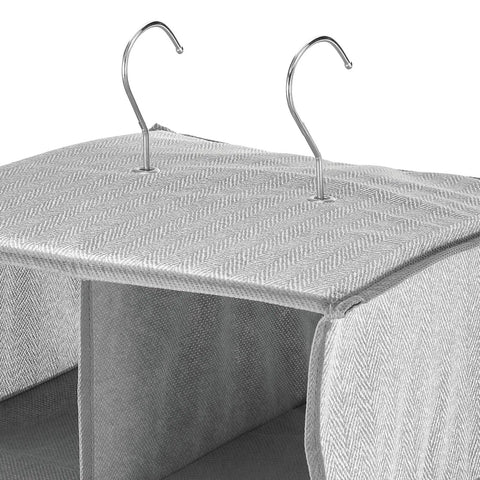Close-up of steel hooks on soft fabric closet organizer with 20 shelf over rod vertical storage, black cream color.