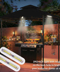5x8 Grill Gazebo With Extra Shade Awning Party Ready Vibe All Weather Steel Frame Double Tier Canopy Roof Sturdy Metal Serving Shelves Built In LED Lights Bottle Opener Patio Backyard BBQ Shelter Black with grill and LED lighting at night