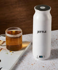Travel Stainless Steel Electric Kettle 450ml With Temperature Control LED Auto Shutoff next to glass mug on countertop