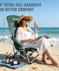 Person relaxing on Low Beach Chair With High Back Foldable And Lightweight For Outdoor Use Great For Beach Camping Lawn And Festivals Includes Cup Holder And Carry Bag Ergonomic Back Support Durable 600D Fabric In Vintage Green Leaves on a beach.