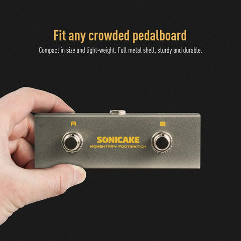 Hand holding dual footswitch pedal for guitar FX rig, compact design, ultra fast non latching momentary switches, TRS cable included.
