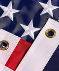 Close-up of Heavy Duty 5x8 Ft US Flag With Embroidered Stars And Sewn Stripes, Nylon Construction, Brass Grommets, UV Protected For Outdoors