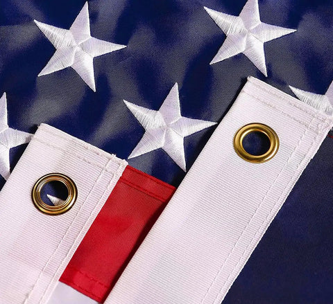 Close-up of Heavy Duty 5x8 Ft US Flag With Embroidered Stars And Sewn Stripes, Nylon Construction, Brass Grommets, UV Protected For Outdoors