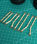 Beefy Brass High Clearance Chassis Links Set For 1/18 TRX4M Defender Bronco RC Crawler Upgrades, 42g Heavy Bent Links on grid mat