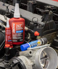 Blue Threadlocker 243 Medium Strength Oil Tolerant Thread Locking Adhesive For Everyday Use Removable When Needed 6 Tubes Of 6 Ml Each Pack Of 6 displayed near engine components.