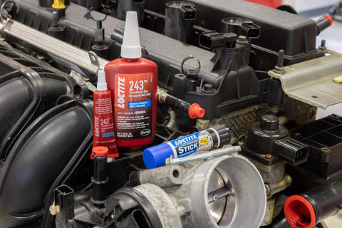 Blue Threadlocker 243 Medium Strength Oil Tolerant Thread Locking Adhesive For Everyday Use Removable When Needed 6 Tubes Of 6 Ml Each Pack Of 6 displayed near engine components.