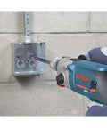 Bosch hammer drill with SDS-Plus Speedcore thin-wall core bit drilling into a metal electrical box on a concrete wall