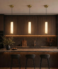 Omgomne Natural Spanish Alabaster Pendant Light 11.8 inch above a modern kitchen island with dark wood cabinets.