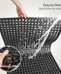 Outdoor Rubber Mat For Kitchens And Restaurants, Anti Fatigue Floor Mat 24 X 36 Inches With Drainage Holes, shown being rinsed
