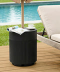 Tough As Nails 90lb Water Filled Patio Umbrella Base With Built In Ice Cooler next to poolside chair on deck