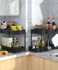 Heavy Duty Black Under Sink Organizer 2 Pack With Smooth Glide Sliding Drawers For Bathroom Cabinet in kitchen corner displaying spice jars and sauces.