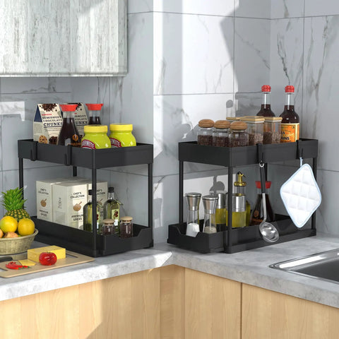 Heavy Duty Black Under Sink Organizer 2 Pack With Smooth Glide Sliding Drawers For Bathroom Cabinet in kitchen corner displaying spice jars and sauces.