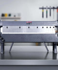 Front view of Box and Pan Brake 24 Inch Sheet Metal Bender, 16-Gauge Mild Steel Capacity, adjustable aluminum folder on workbench.